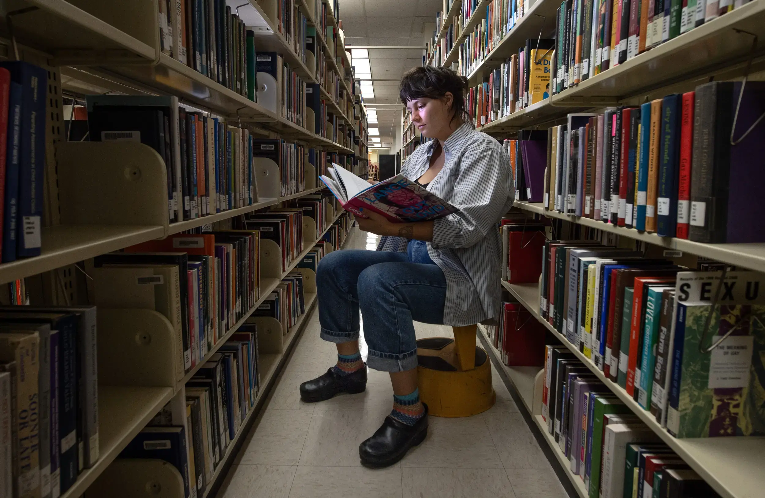 Girl reading a book in the library