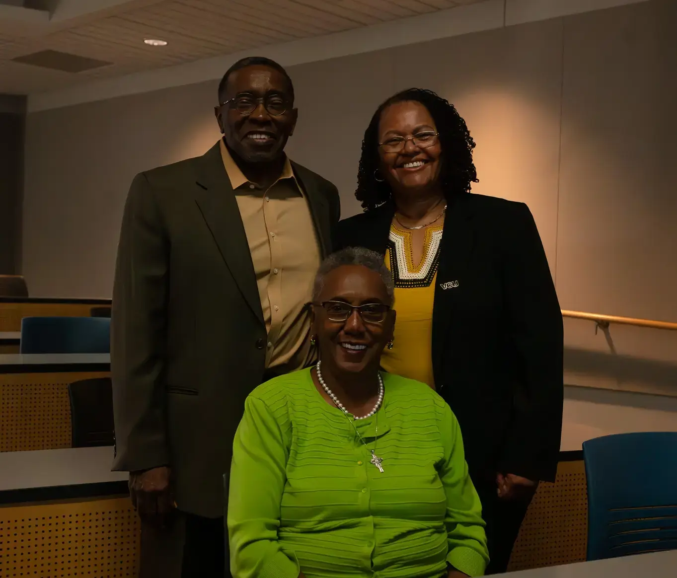 Christopher Brooks, Ph.D., (standing left), Naomi Hodge-Muse (seated) and Faye Z. Belgrave, Ph.D., chief diversity officer and vice president for inclusive excellence, at a recent event celebrating 