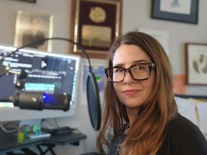 erin croyle sitting at a table with audio equipment