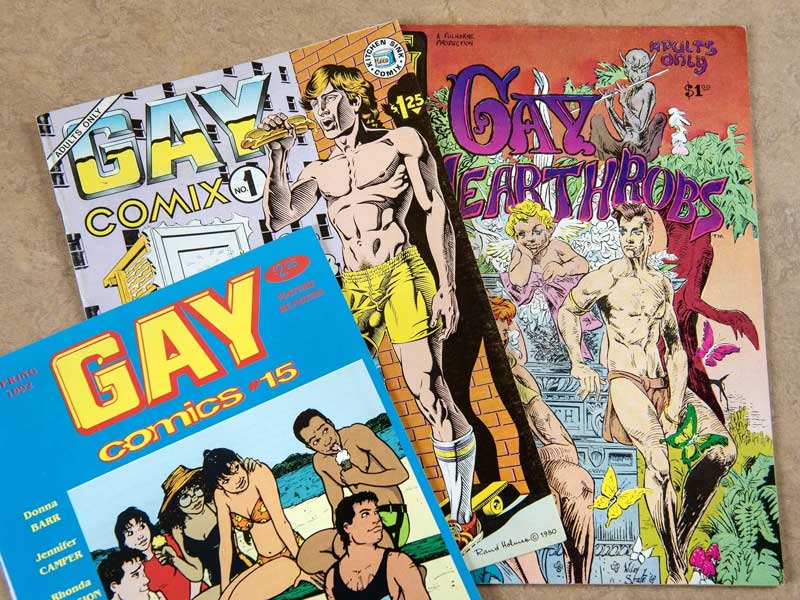 one comic book called gay comics with people on the beach on the cover, one comic book called gay comix with a man eating a hot dog on the cover, and one comic book called gay hearthrobs