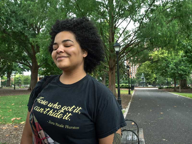 jae lange smiling contentedly while walking in monroe park at v.c.u.