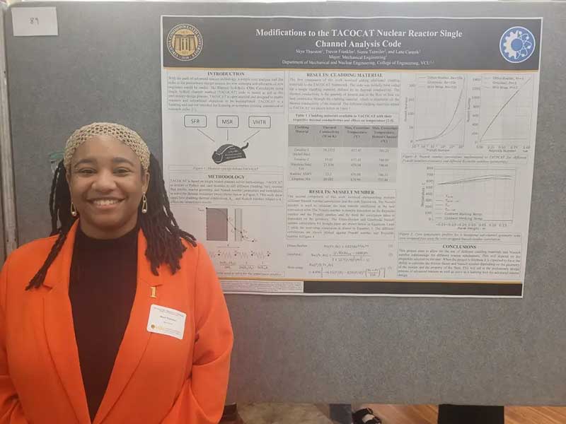 skye thurston stands in front of a research poster titled 'modifications to the t.a.c.o.c.a.t. nuclear reactor single channel analysis code