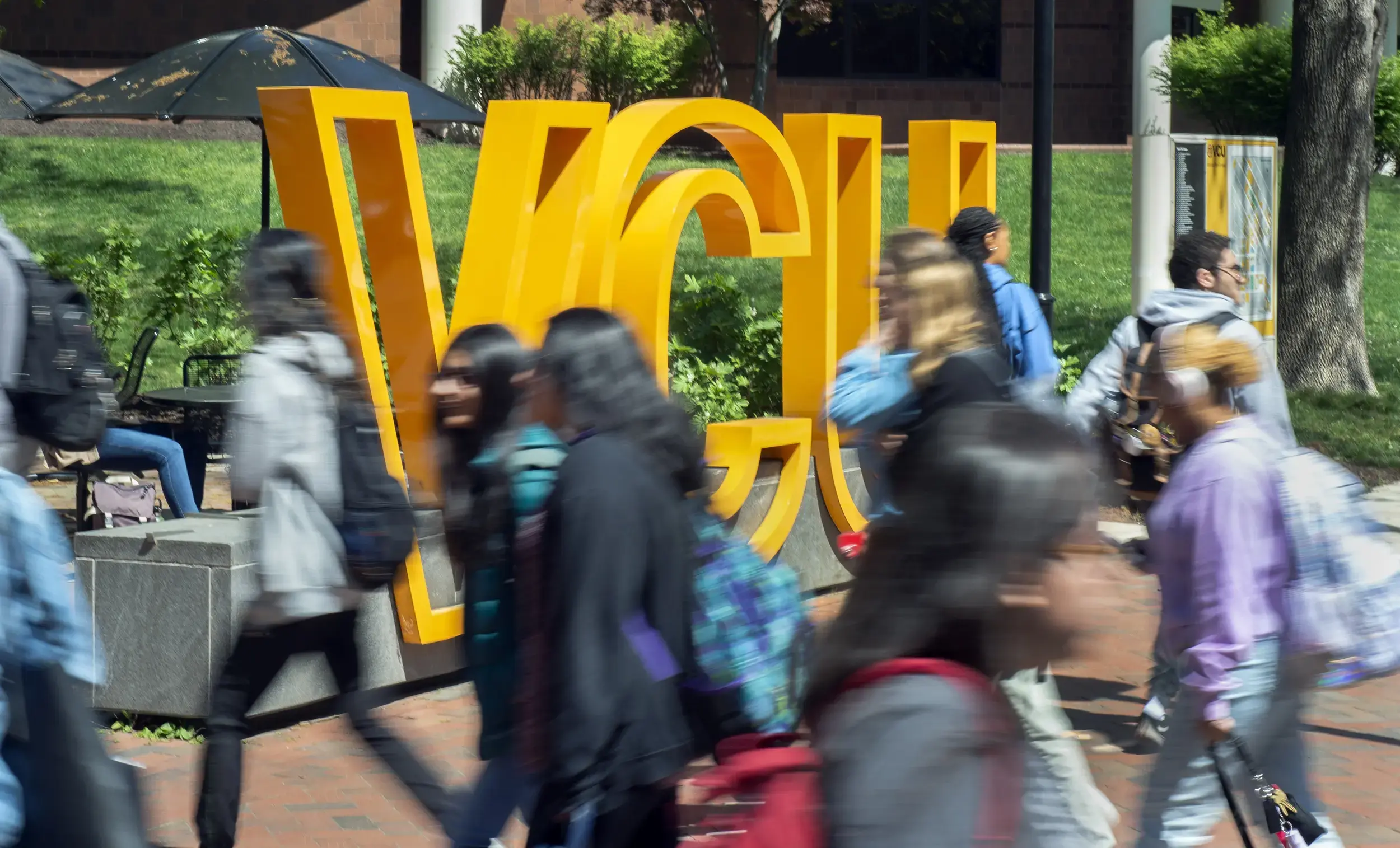 VCU sign with people in front of walking